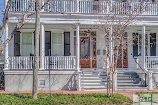 view of exterior entry featuring a porch