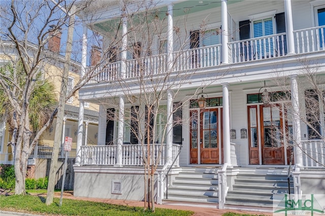 view of front of home featuring crawl space, a chimney, and covered porch