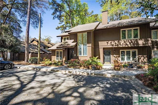 69 Brown Pelican Dr, Savannah, GA 31419 - view of front facade with fence, french doors, and a chimney