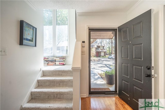 69 Brown Pelican Dr, Savannah, GA 31419 - foyer featuring crown molding, wood-type flooring, a textured ceiling, and stairway