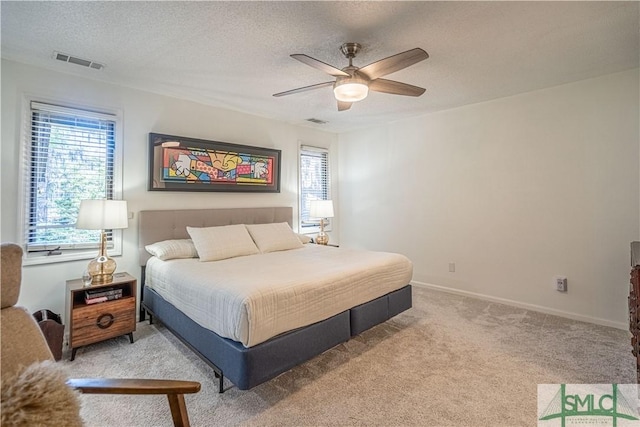 69 Brown Pelican Dr, Savannah, GA 31419 - bedroom featuring visible vents, multiple windows, light carpet, and a textured ceiling