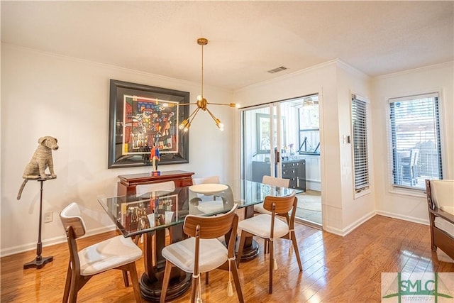 69 Brown Pelican Dr, Savannah, GA 31419 - dining space with wood-type flooring, ornamental molding, visible vents, and plenty of natural light