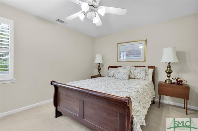 bedroom featuring visible vents, baseboards, a ceiling fan, and light carpet