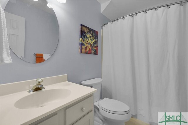 bathroom with vanity, a shower with curtain, and toilet