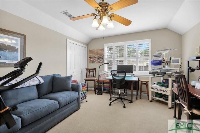 carpeted home office featuring visible vents, a ceiling fan, and vaulted ceiling