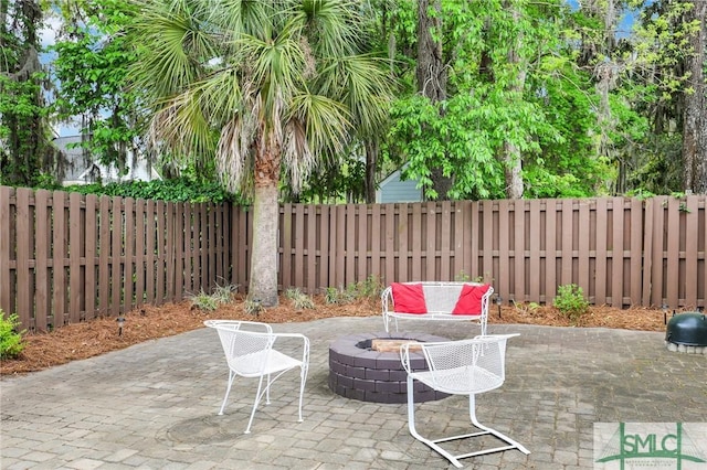 view of patio / terrace featuring an outdoor fire pit and a fenced backyard
