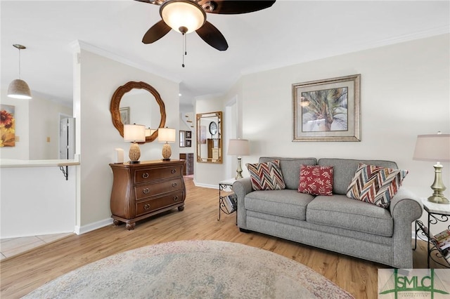 living room featuring crown molding, wood finished floors, ceiling fan, and baseboards
