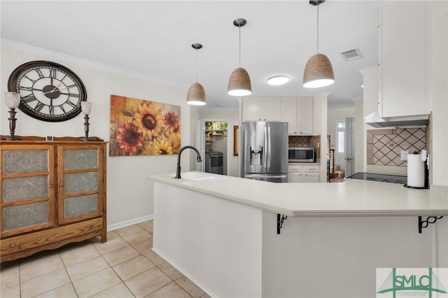 kitchen with a peninsula, white cabinetry, visible vents, a sink, and stainless steel appliances