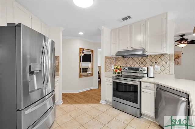 kitchen with visible vents, light countertops, appliances with stainless steel finishes, under cabinet range hood, and backsplash