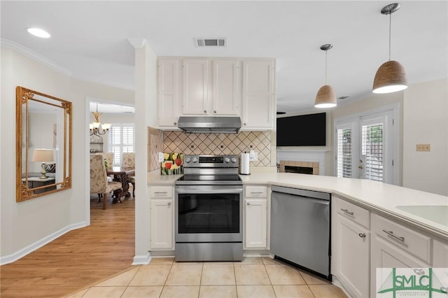 kitchen with an inviting chandelier, white cabinetry, visible vents, appliances with stainless steel finishes, and under cabinet range hood