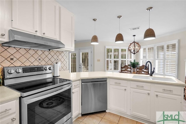 kitchen featuring visible vents, under cabinet range hood, light countertops, a sink, and stainless steel appliances