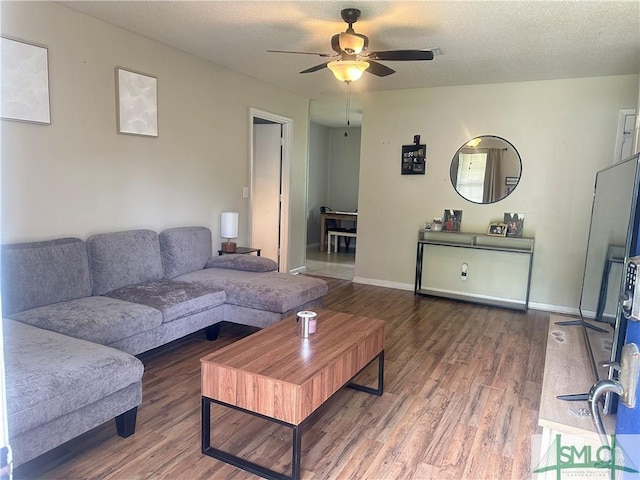 712 Fleming Rd, Hinesville, GA 31313 - living area with ceiling fan, baseboards, wood finished floors, and a textured ceiling