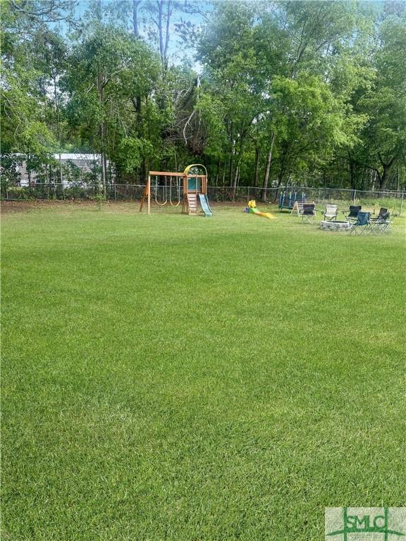 712 Fleming Rd, Hinesville, GA 31313 - view of yard with playground community and fence