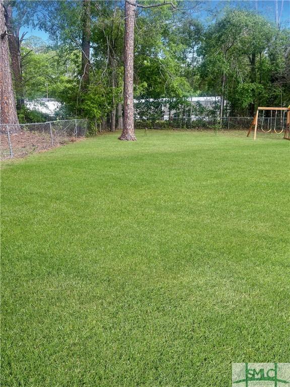 712 Fleming Rd, Hinesville, GA 31313 - view of yard featuring fence and a playground
