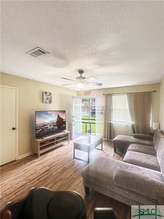 712 Fleming Rd, Hinesville, GA 31313 - living room featuring a textured ceiling, wood finished floors, ceiling fan, and visible vents