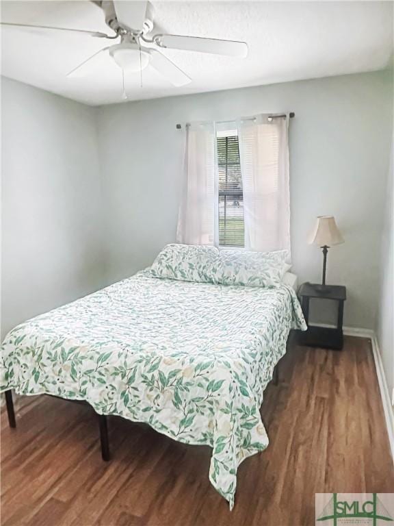 712 Fleming Rd, Hinesville, GA 31313 - bedroom with baseboards, a ceiling fan, and wood finished floors