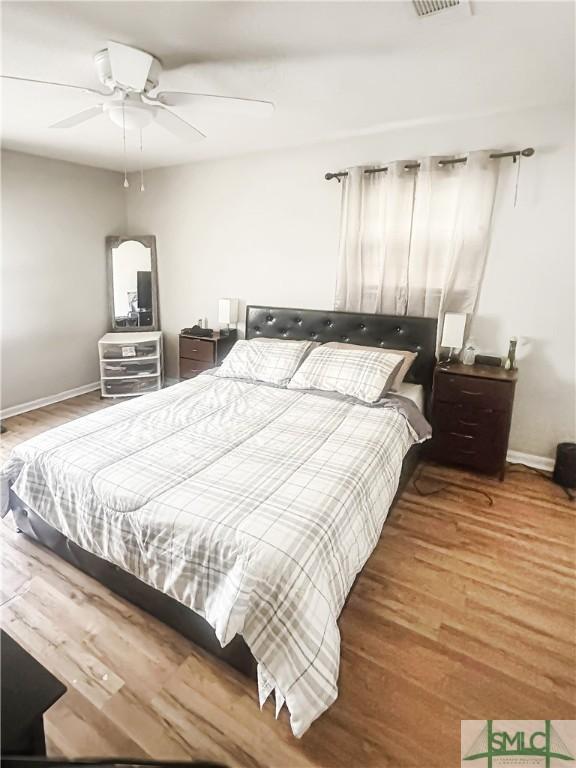 712 Fleming Rd, Hinesville, GA 31313 - bedroom with wood finished floors, baseboards, and a ceiling fan