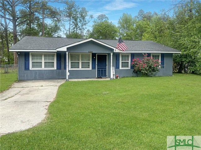 712 Fleming Rd, Hinesville, GA 31313 - ranch-style home with roof with shingles, driveway, a front yard, and fence