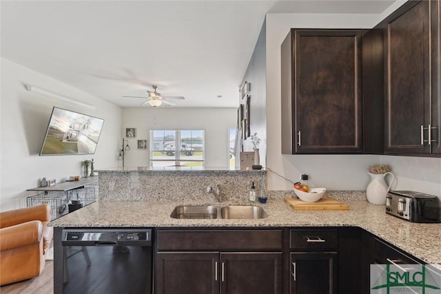 kitchen featuring dark brown cabinetry, a peninsula, a ceiling fan, black dishwasher, and a sink