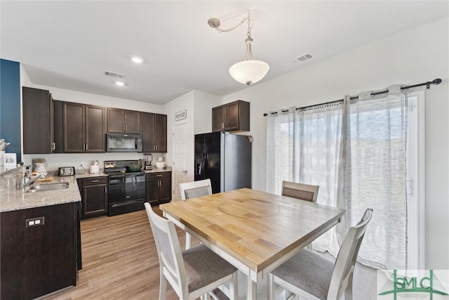 dining area featuring visible vents and light wood finished floors