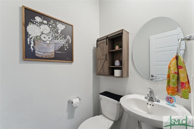 bathroom with toilet and a sink