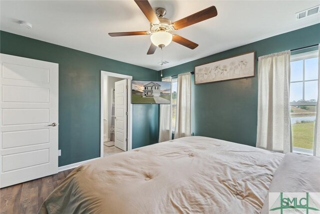 bedroom with visible vents, baseboards, a ceiling fan, and connected bathroom