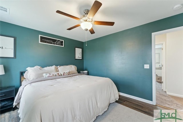 bedroom featuring visible vents, baseboards, a ceiling fan, and wood finished floors