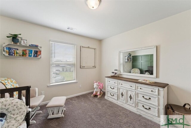 carpeted bedroom with visible vents and baseboards