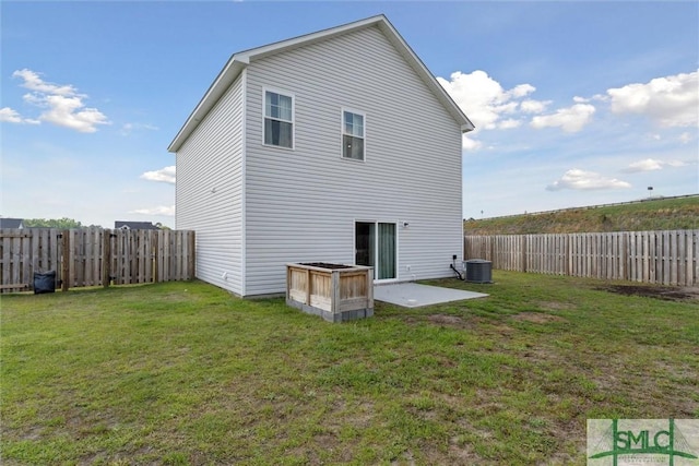 rear view of house featuring central air condition unit, a yard, and a fenced backyard