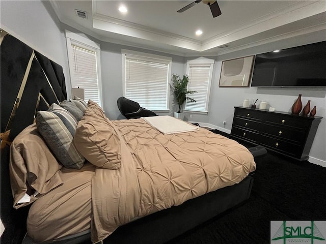 carpeted bedroom with visible vents, ornamental molding, a raised ceiling, and baseboards