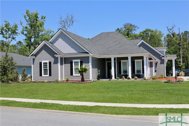 craftsman inspired home featuring a porch, a front lawn, and board and batten siding