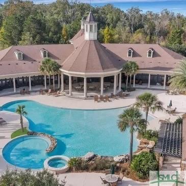 view of swimming pool featuring a patio, a gazebo, and a pool with connected hot tub