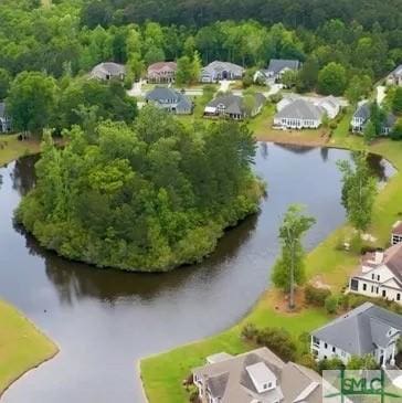 bird's eye view featuring a water view, a view of trees, and a residential view