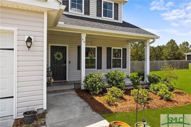 40 Saddlebrush Rd, Ellabell, GA 31308 - property entrance featuring a porch, a yard, a shingled roof, and fence