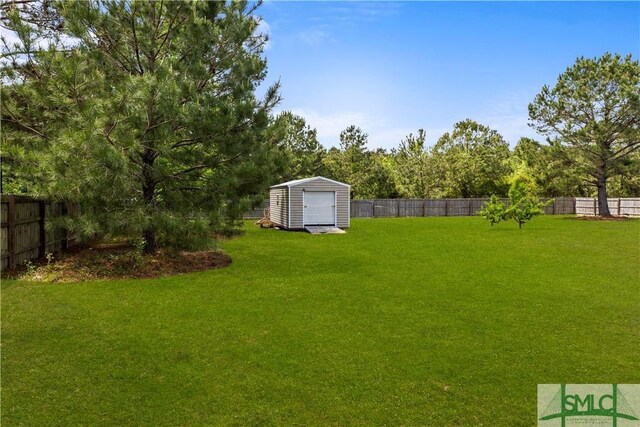 40 Saddlebrush Rd, Ellabell, GA 31308 - view of yard featuring a shed, a fenced backyard, and an outbuilding
