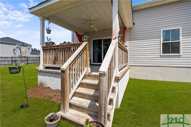 40 Saddlebrush Rd, Ellabell, GA 31308 - wooden deck featuring a yard, fence, stairs, and ceiling fan