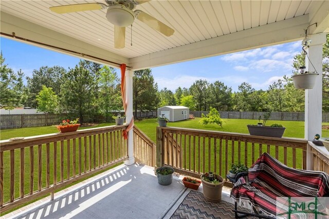 40 Saddlebrush Rd, Ellabell, GA 31308 - view of patio featuring an outbuilding, ceiling fan, a fenced backyard, a storage unit, and a deck