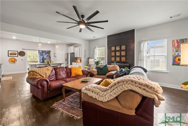 40 Saddlebrush Rd, Ellabell, GA 31308 - living room with dark wood-style flooring, visible vents, and a healthy amount of sunlight