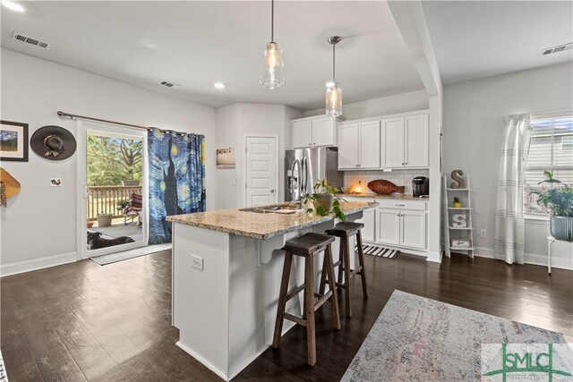 40 Saddlebrush Rd, Ellabell, GA 31308 - kitchen featuring stainless steel fridge with ice dispenser, dark wood finished floors, visible vents, and a wealth of natural light