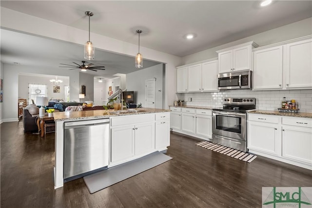 40 Saddlebrush Rd, Ellabell, GA 31308 - kitchen featuring a center island, dark wood-style flooring, open floor plan, white cabinetry, and stainless steel appliances