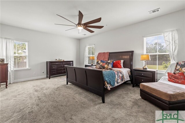 40 Saddlebrush Rd, Ellabell, GA 31308 - carpeted bedroom featuring visible vents, multiple windows, baseboards, and ceiling fan
