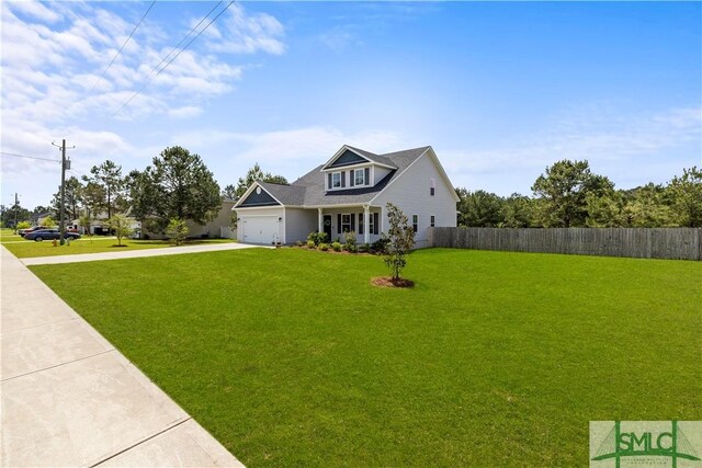 40 Saddlebrush Rd, Ellabell, GA 31308 - view of front facade with concrete driveway, an attached garage, fence, and a front lawn