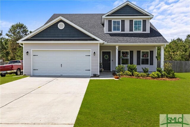 40 Saddlebrush Rd, Ellabell, GA 31308 - craftsman-style house featuring a front yard, a shingled roof, an attached garage, fence, and driveway