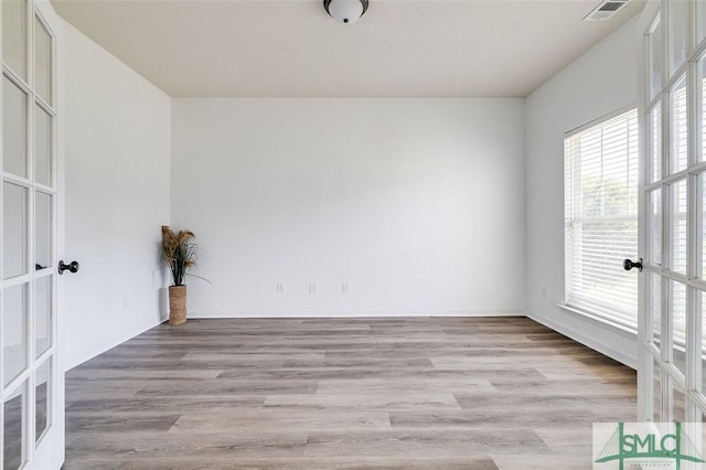 106 Cedar Ridge Dr, Guyton, GA 31312 - empty room with french doors and light wood-style flooring