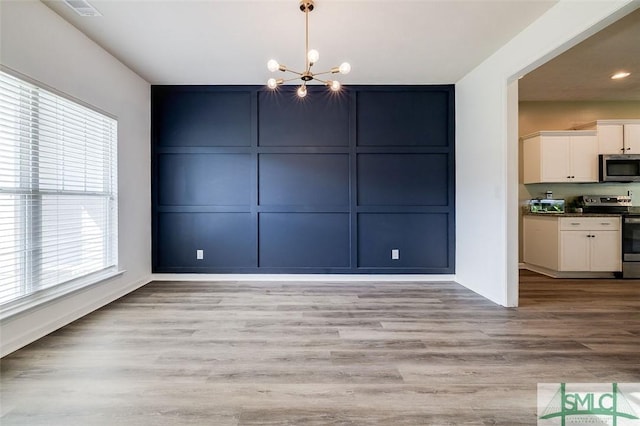 106 Cedar Ridge Dr, Guyton, GA 31312 - unfurnished dining area with a decorative wall, a chandelier, baseboards, light wood finished floors, and recessed lighting