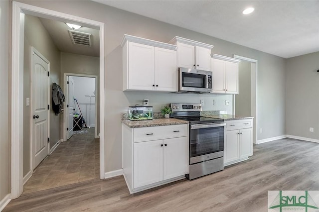 106 Cedar Ridge Dr, Guyton, GA 31312 - kitchen featuring stainless steel appliances, baseboards, white cabinets, light stone countertops, and recessed lighting
