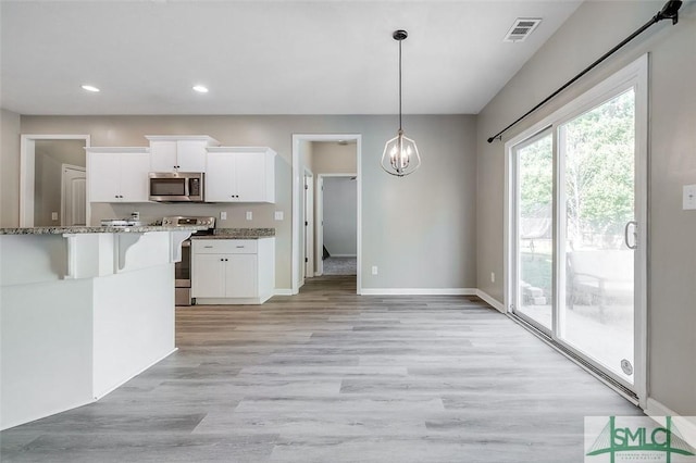 106 Cedar Ridge Dr, Guyton, GA 31312 - kitchen featuring appliances with stainless steel finishes, stone countertops, white cabinetry, recessed lighting, and light wood finished floors