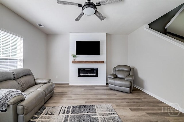 106 Cedar Ridge Dr, Guyton, GA 31312 - living room with ceiling fan, a large fireplace, baseboards, and wood finished floors