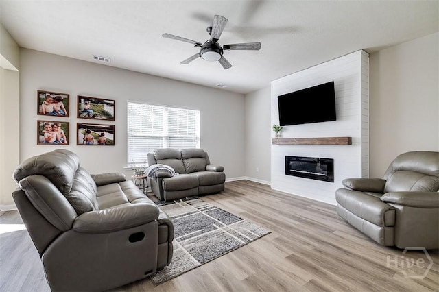 106 Cedar Ridge Dr, Guyton, GA 31312 - living area with ceiling fan, wood finished floors, a fireplace, and baseboards