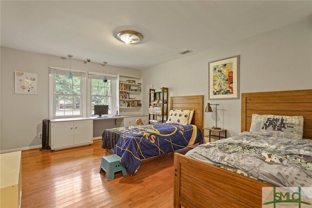 bedroom with visible vents and light wood-style floors